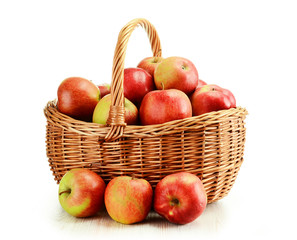 Apples and wicker basket isolated on white