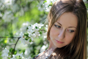 Portrait of beautiful blond in spring blossom