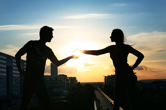Young couple over evening city background