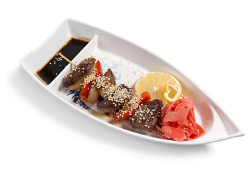 Shish kebab on a plate in the form of a boat