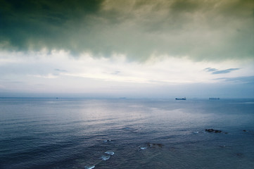 Fototapeta premium Storm clouds over the island in sea