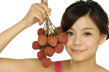Young woman holding brunch of litchi fruits,
