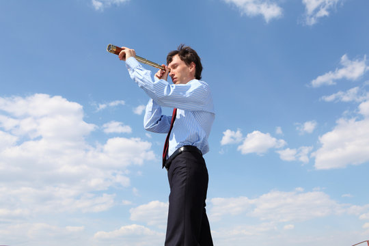 Young Business Man  Looks Through A Telescope