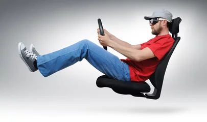 Photo sur Plexiglas Voitures rapides Cool dude with the wheel flies on an office chair concept