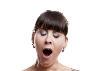 Close-up portrait of a sleepy woman yawn