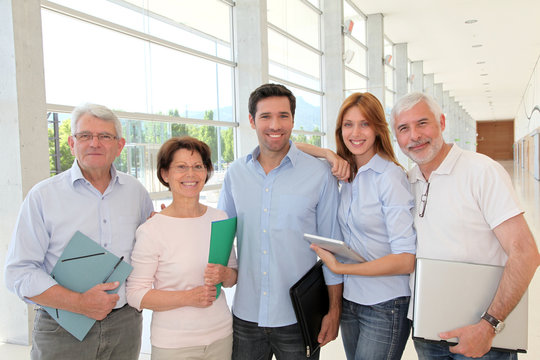 Group of happy senior people in training course