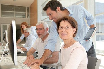 Portrait of senior woman attending computing training
