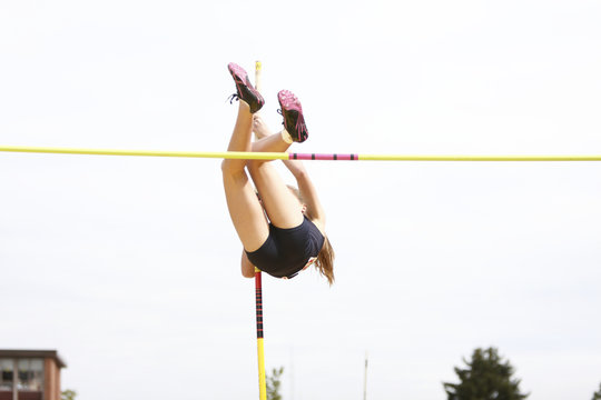 Female athlete competing in the pole vault