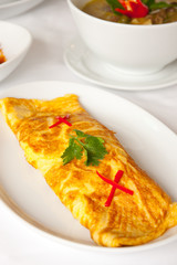Omelet on white dish, Thai food