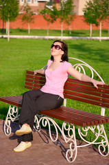 Young smiling woman on a bench