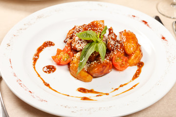 portion of sesame chicken served on a white plate