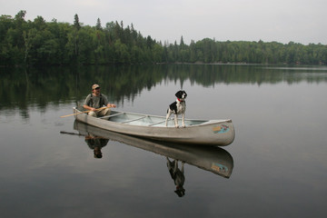 Fototapeta na wymiar Canoeist and Dog - Ontario, Canada