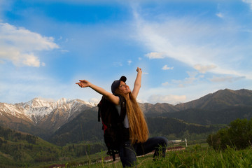 girl with a backpack in the mountains