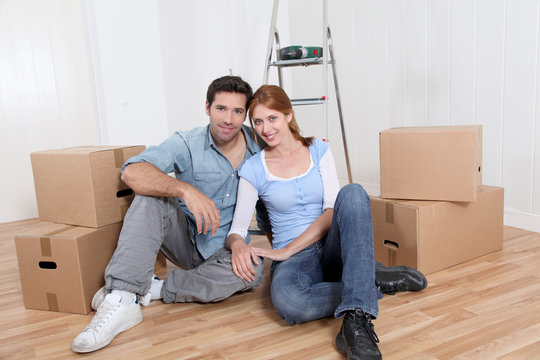 Young couple sitting in their new house