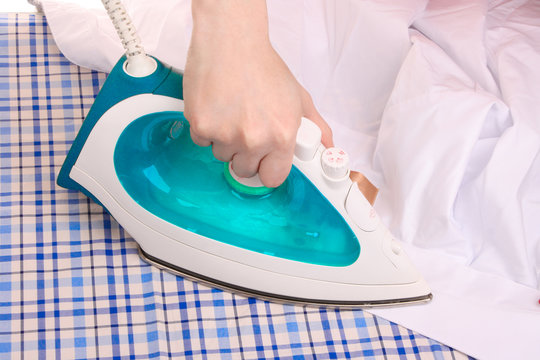 Woman hand ironing a shirt