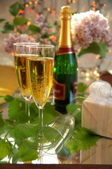 Champagne in glasses and green grape-vine