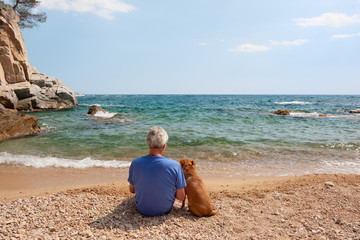 Fototapeta premium Man with his dog at the beach