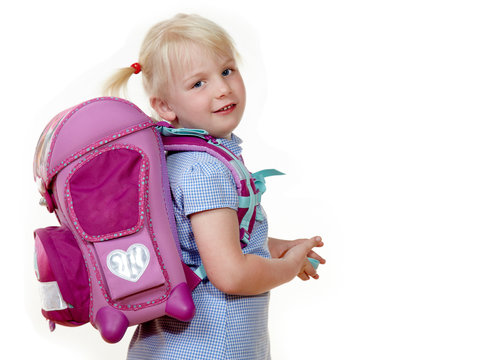 Cute girl with her school bag starts at school