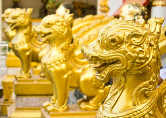Head close up of thai lions statue standing in front of the temp