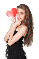 Portrait of young female in black holding heart shape