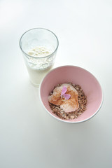 Bowl of muesli and glass of milk