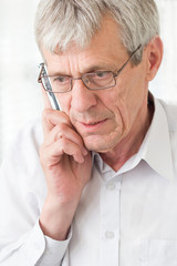 Worried older man talking on phone