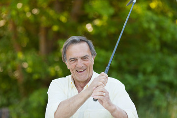älterer mann spielt golf