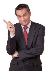 Attractive Smiling Middle Age Business Man in Suit Pointing Left