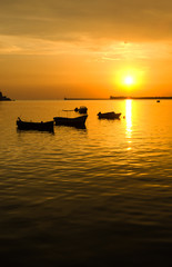 Sea, the silhouettes of boats and a beautiful sunset