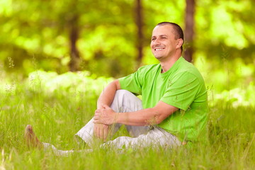 Naklejka na ściany i meble Young man relaxing in the forest