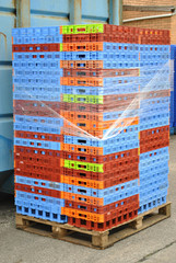 Orange blue and yellow crates stacked on a pallet