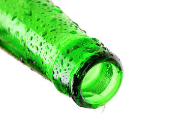 Macro shot of beer bottle with water drops isolated on white