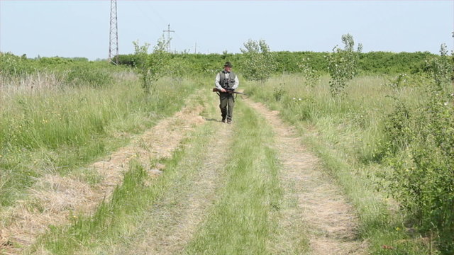 hunter walking and aiming