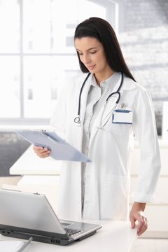 Doctor in office with clipboard