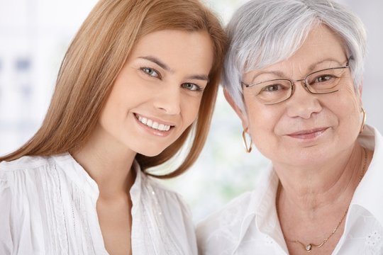 Closeup portrait of young woman and mother smiling