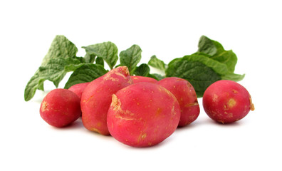 Fototapeta na wymiar Red new potatoes with green leaves