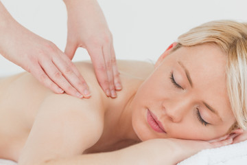 Obraz na płótnie Canvas Closeup of young beautiful blonde woman receiving a back massage