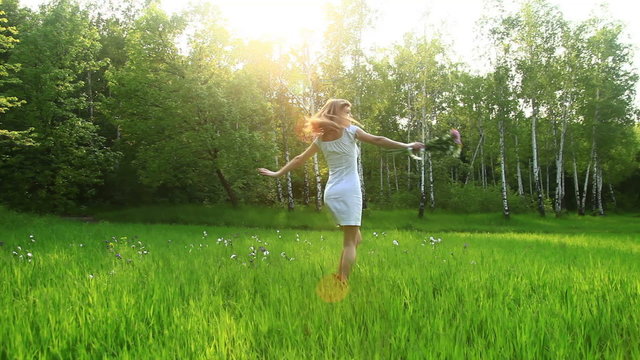 Beautiful woman spinning in the grass. Dolly HD