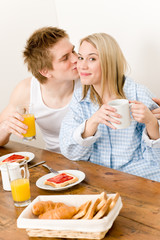 Obraz na płótnie Canvas Breakfast happy couple enjoy romantic kiss