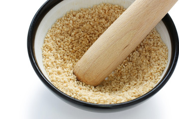 grind sesame with mortar and wooden pestle