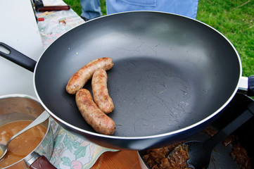 Sausages in frying pan