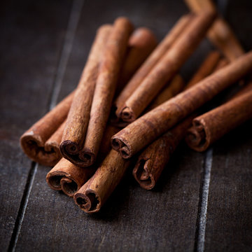 Cinnamon sticks on rustic wooden background