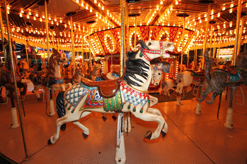 Beautifully decorated carousal horses on a merry-go-round