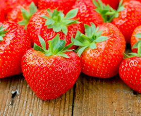 Strawberries on wooden bench.