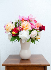 Colorful flower bouquet in front of white wall