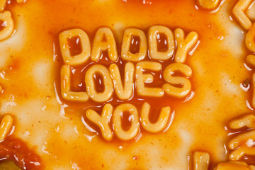 Pasta forming DADDY LOVES YOU in tomato sauce