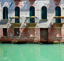Fototapeta na wymiar Front of old venetian house standing in water, Italy