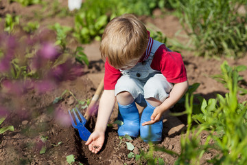 kind arbeitet im garten