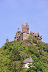 Fototapeta na wymiar German castle on top of a hill with chapel just beneath
