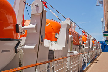 Row of Orange Lifeboats by Deck of Cruise Ship
